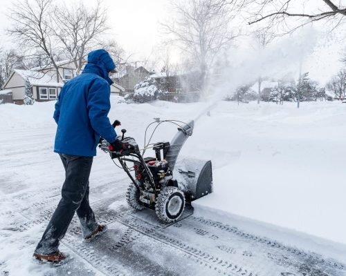 Man Clearing Snow with a Snow Blower